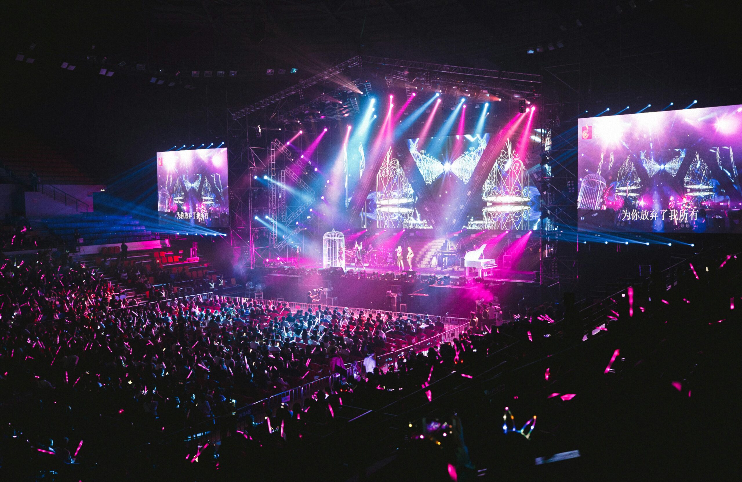 Colorful live concert with vibrant lighting, energetic crowd, and dynamic stage performance.